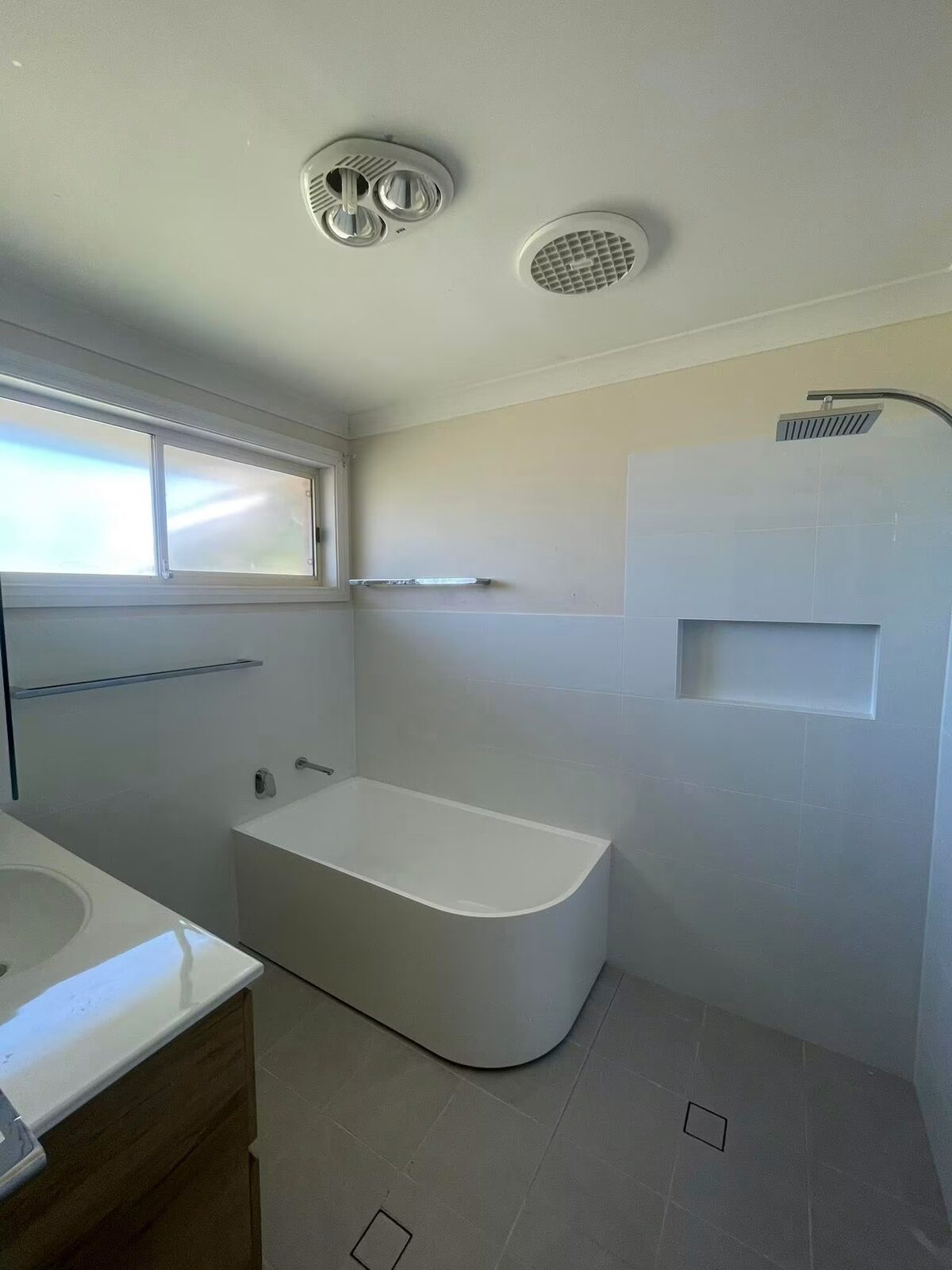 Bathroom renovation with freestanding bath and rain shower by Lleyton Henry Carpentry